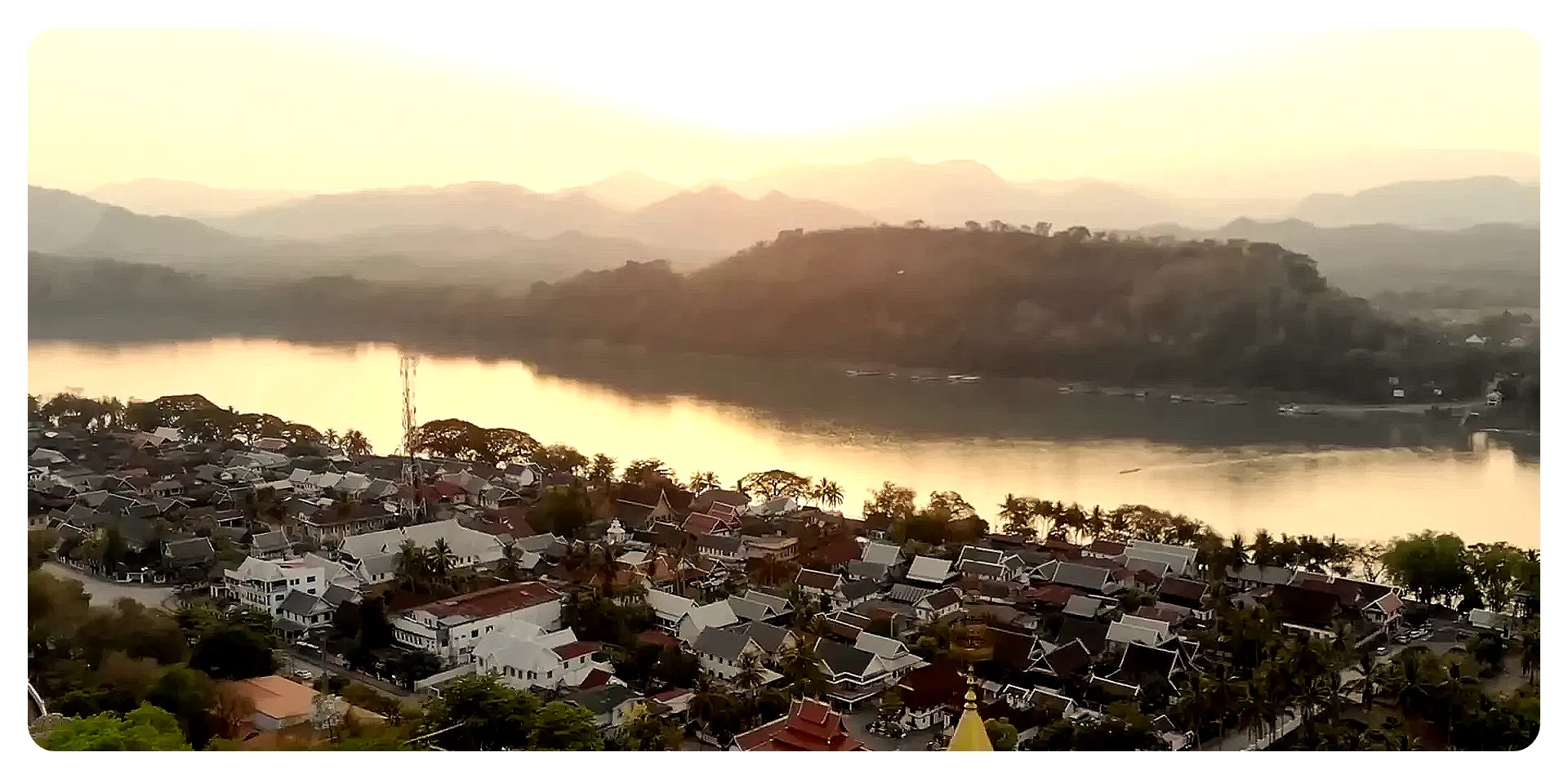 Buddhist temple in Luang Prabang with river and mountains