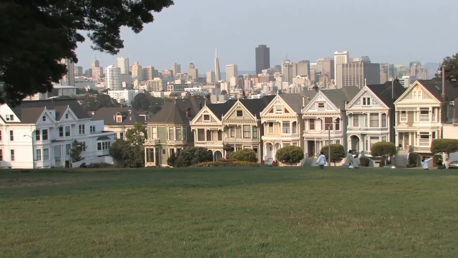 Painted Ladies Victorian houses at Alamo Square with city skyline backdrop
