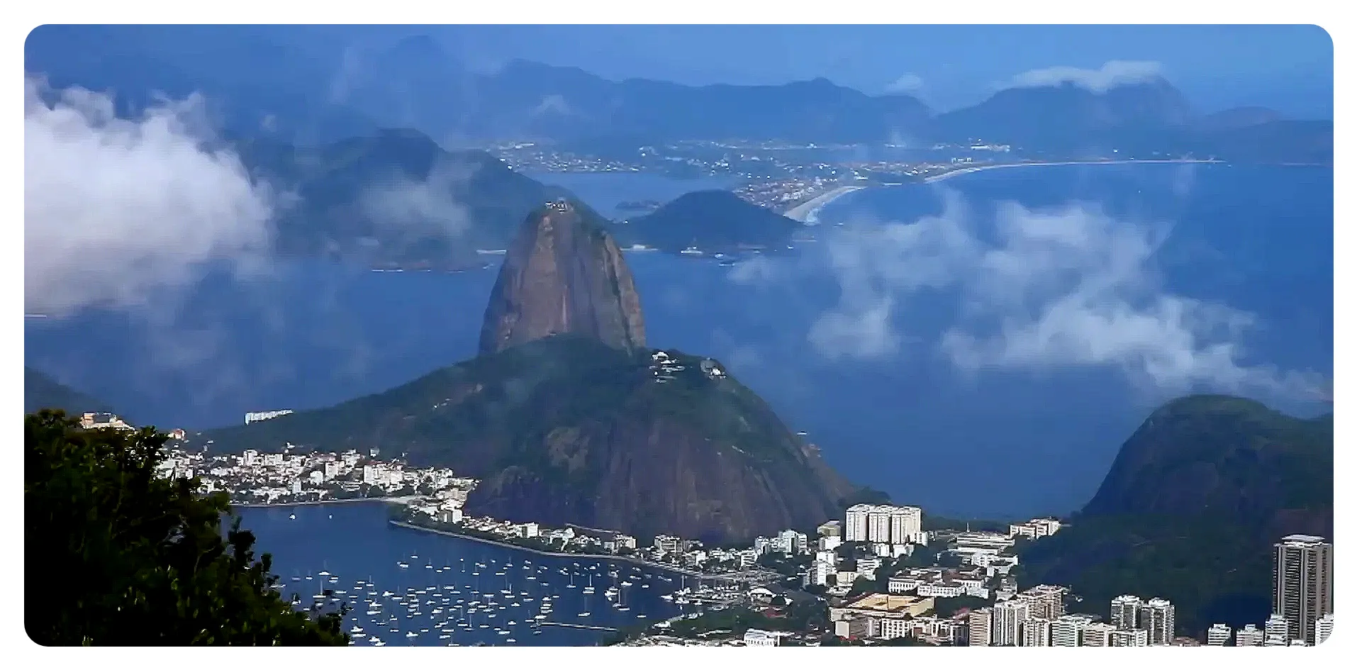 Cable cars ascending Sugarloaf Mountain with city views