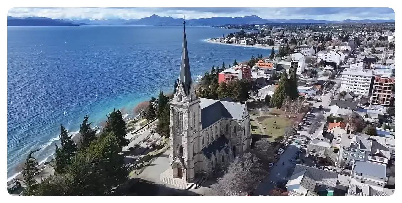 Bariloche lakeside with alpine-style buildings and mountains