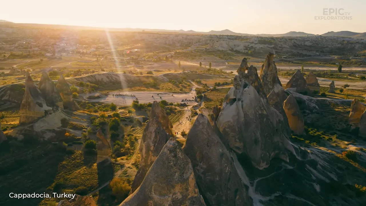 Hot-air balloons drifting over the chimneys and valleys of Cappadocia at sunrise