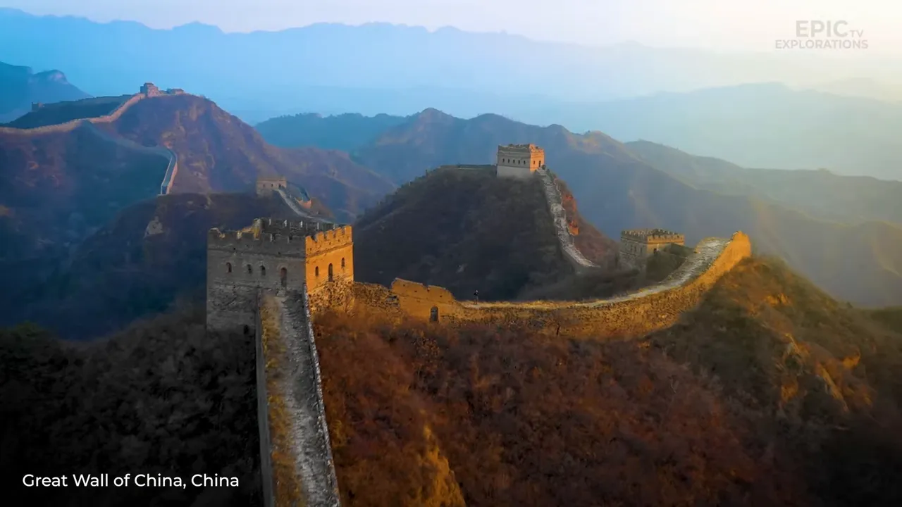 The Great Wall serpentining along mountain ridgelines as morning mist lifts