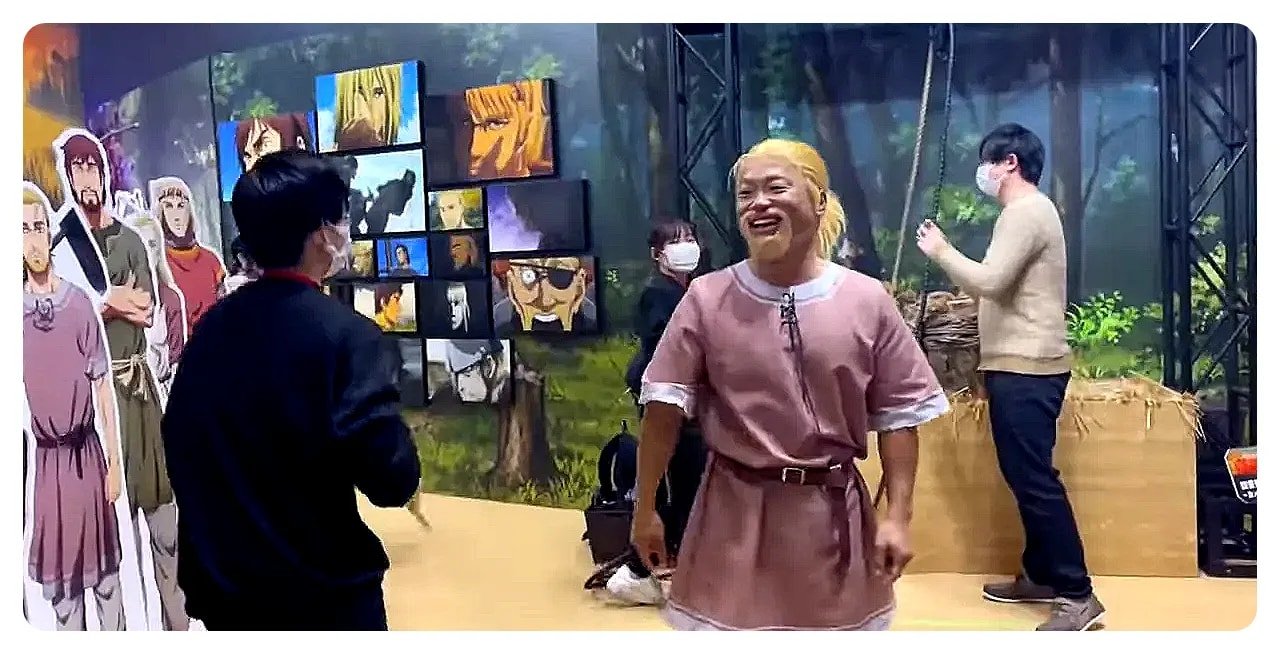 Visitors interacting with a live exhibit and character cutouts at the convention