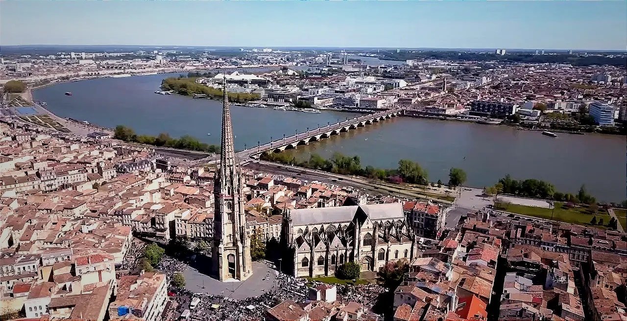 Aerial view of Bordeaux showing the cathedral spire next to the Pont de Pierre bridge crossing the Garonne river