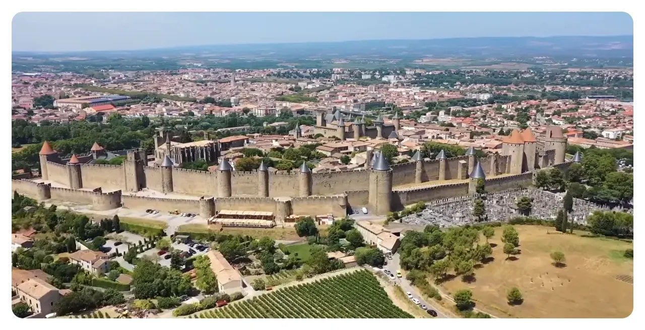 Wide aerial view of the walled citadel of Carcassonne and surrounding town