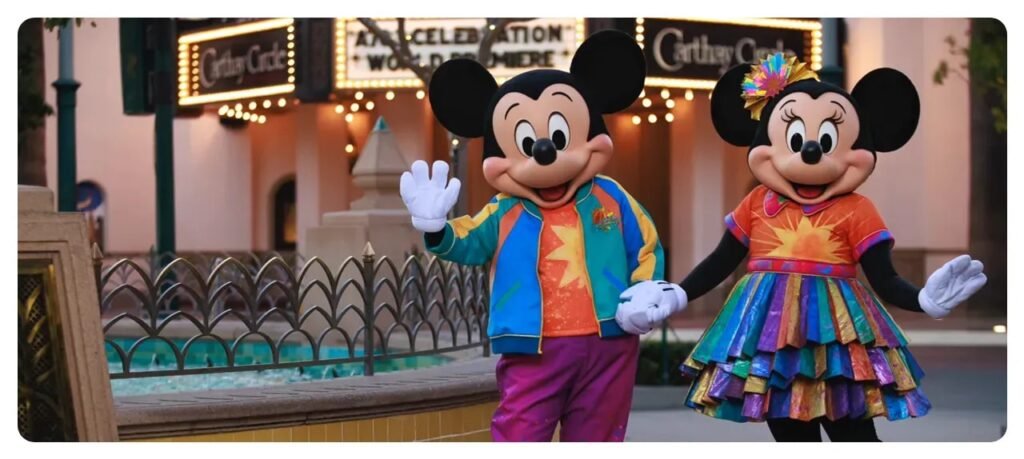 Mickey and Minnie characters in colorful anniversary outfits on Buena Vista Street at Disney California Adventure