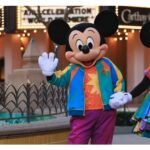 Mickey and Minnie characters in colorful anniversary outfits on Buena Vista Street at Disney California Adventure
