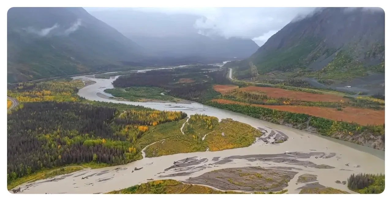 Aerial braided river and tundra with mountains and low cloud in Denali National Park, Alaska