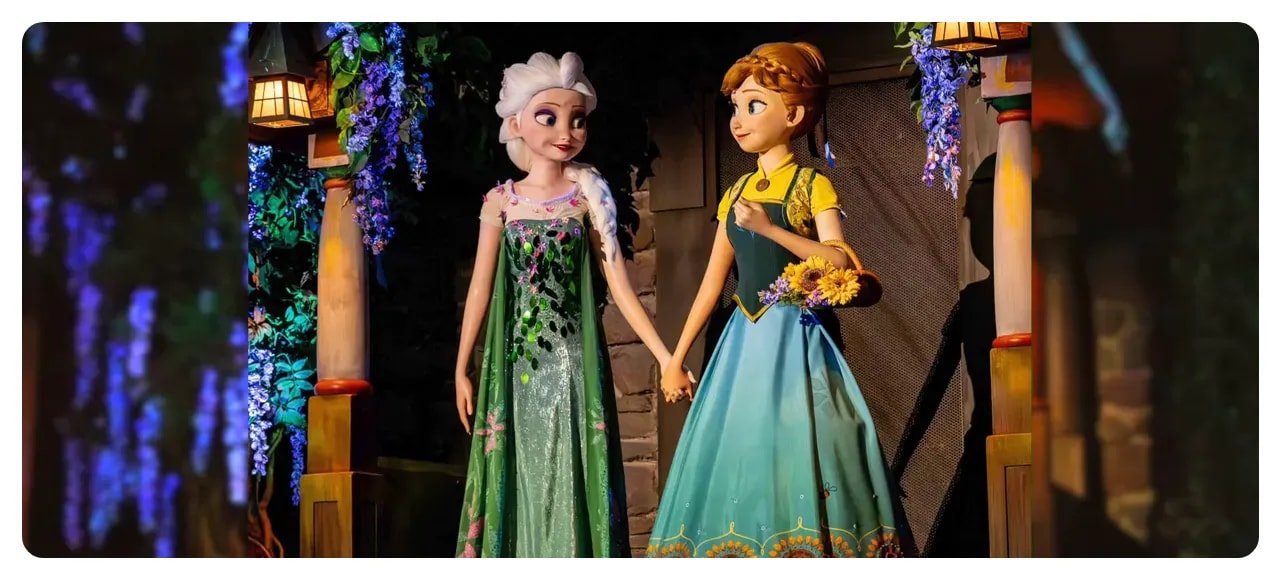 High-resolution image of Elsa and Anna animatronics holding hands on Frozen Ever After showing detailed faces