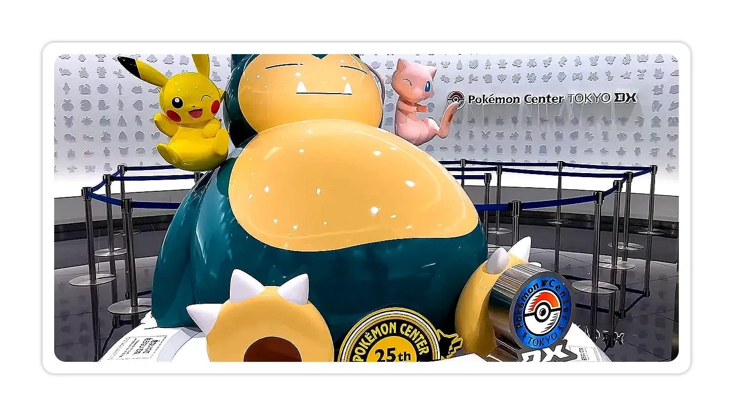 Large Snorlax statue with Pikachu and Mew in front of a Pokémon Center Tokyo DX backdrop and 25th anniversary emblem.